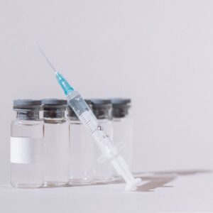 covid vaccine bottles and syringe