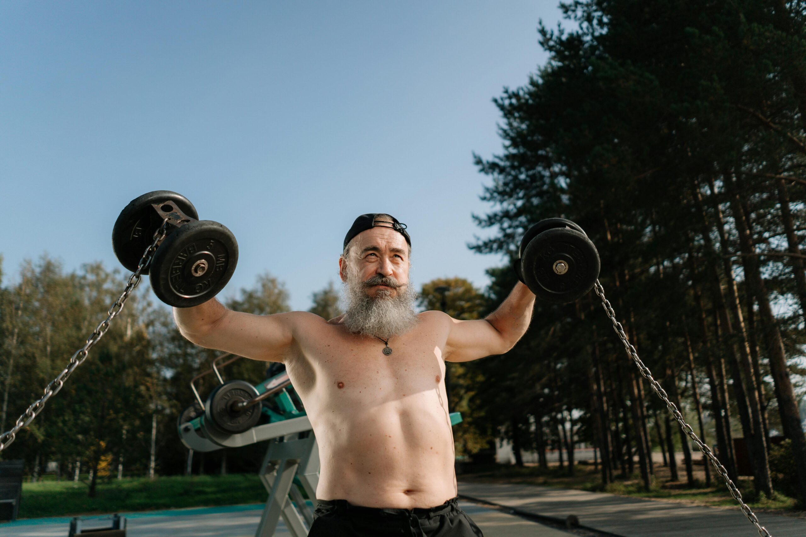 Testosterone quality of life, older man lifting weights.