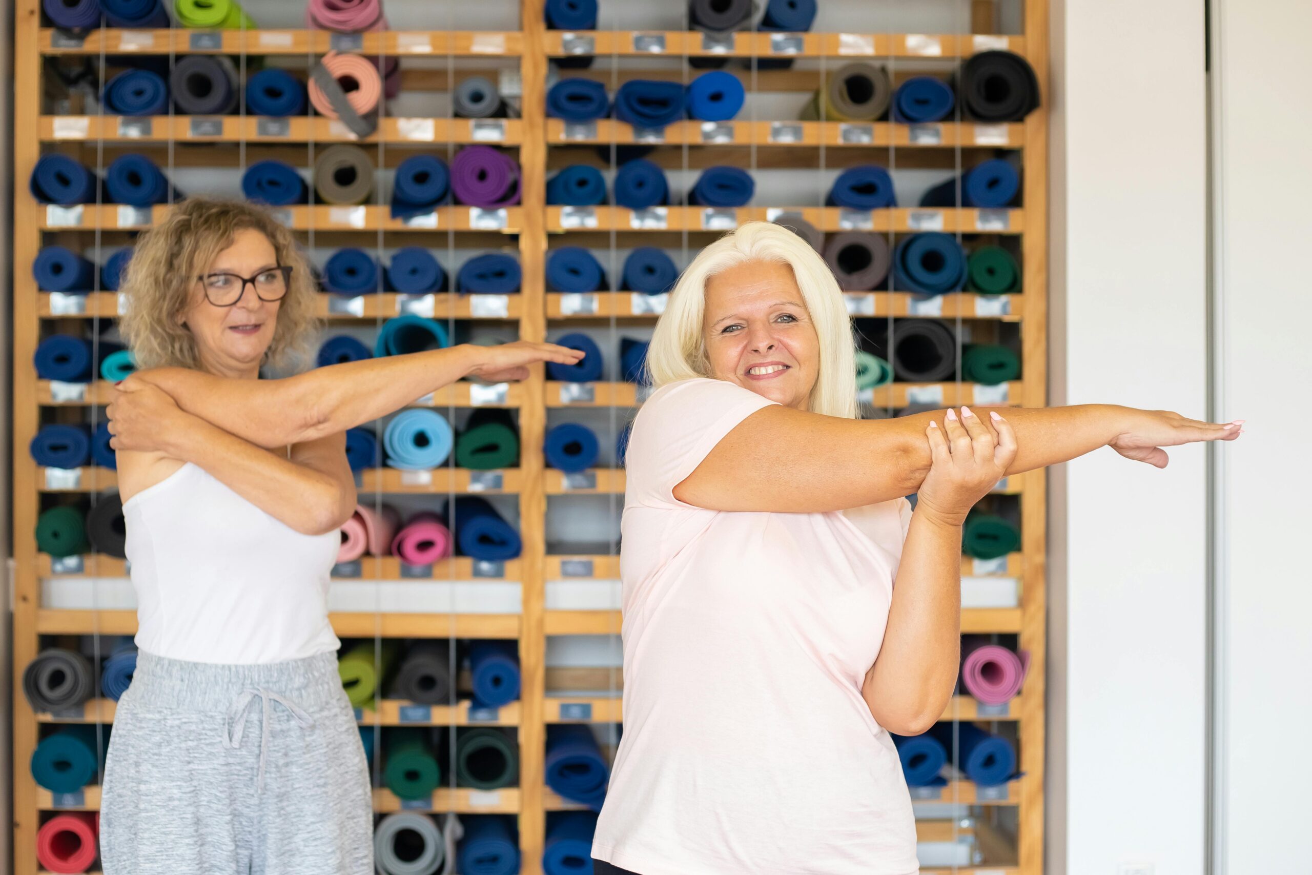 Two ladies stretching before exercise.